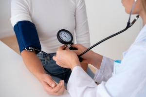 Doctor measuring the blood pressure of the patient